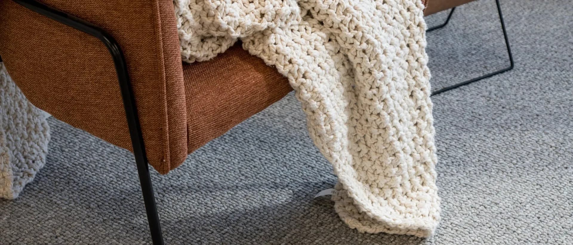 Tuscany — rust armchair with knit throw and magazine rack