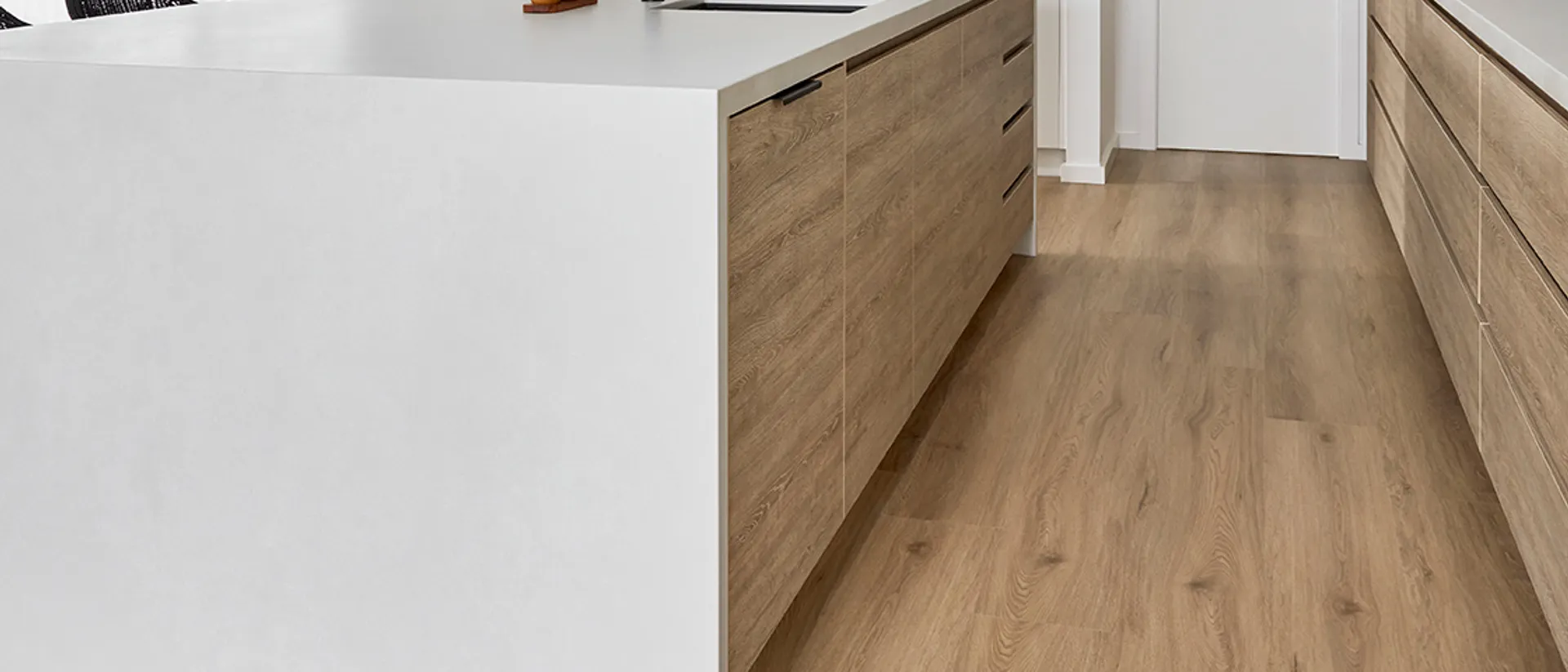 Hydroplank WPC — white kitchen island, warm Hudson Oak plank floor
