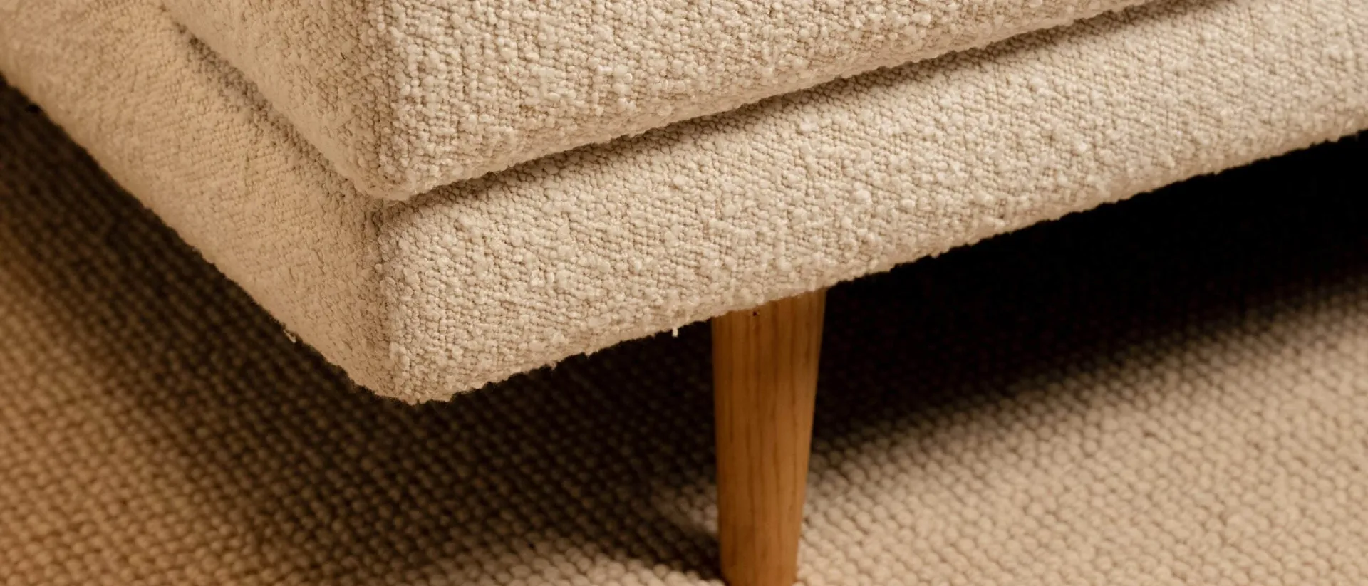 Cotswolds — cream boucle sofa on wool carpet, warm daylight