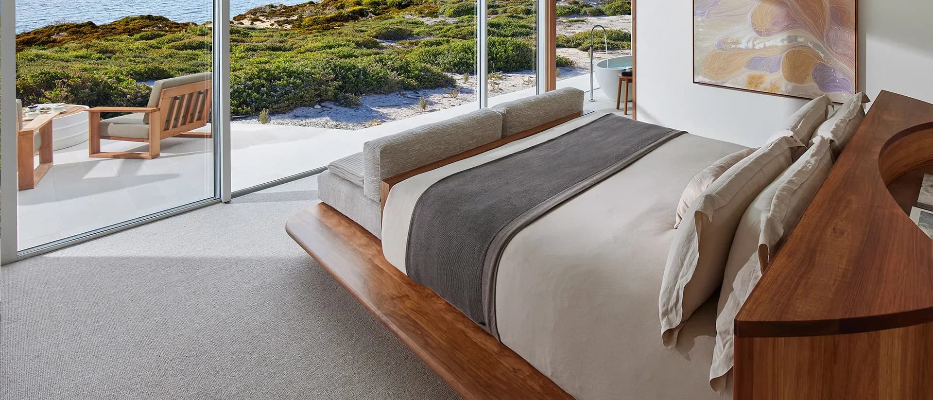 Hause — lodge bedroom with floor-to-ceiling ocean views