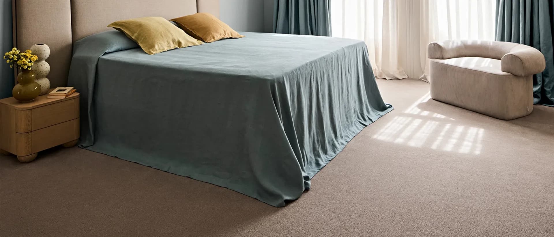 Manningford — sunlit bedroom, blue linen bedspread, blush pink carpet