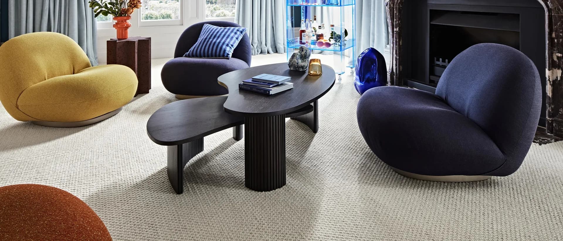 Salisbury — blue-toned living room, marble fireplace, curved chairs, cream carpet