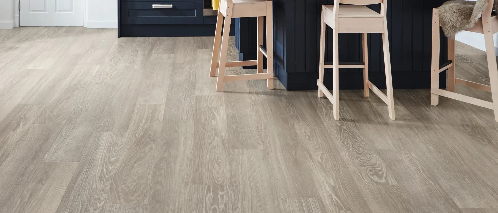 Knight Tile Rigid Core — navy kitchen island, pendants, grey limed oak floor