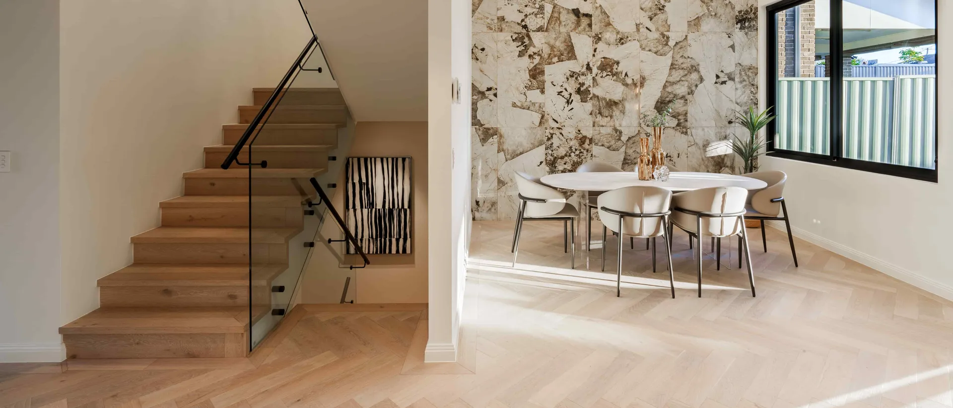 De Marque Oak — staircase and dining on oak herringbone parquetry