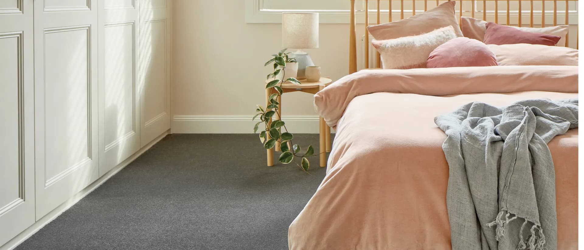 Barossa — bedroom with peach bedding and charcoal grey carpet