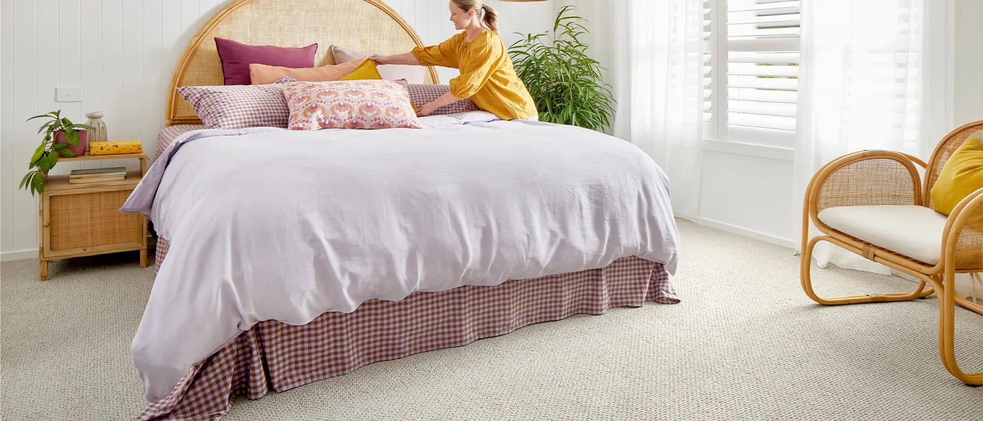 Carpathian — sunlit bedroom, rattan bedhead, wool carpet underfoot
