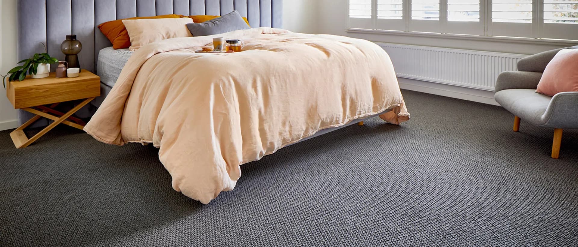 Central Valley — bedroom with peach bedding and dark grey carpet
