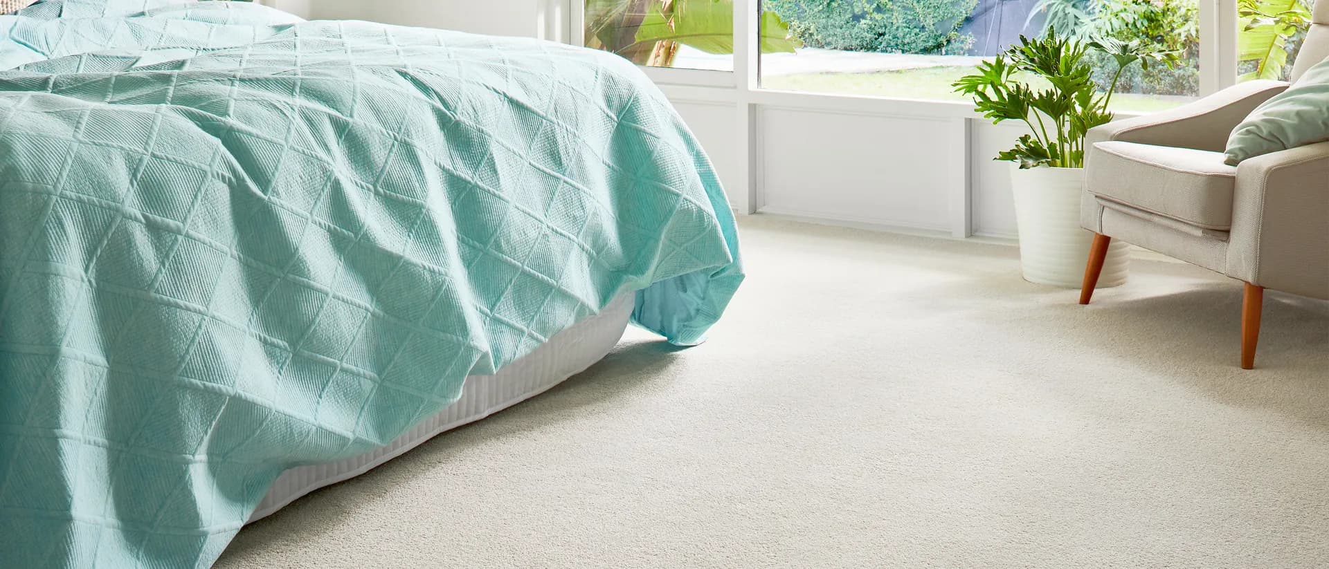 Wild River — bright bedroom, teal bedding, cream carpet, garden window